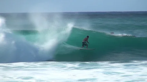 Surfer zips through pipe Stock Footage 92703266
