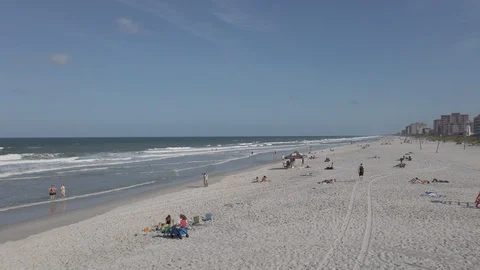 Surfers and beach goers at the beach in Jacksonville, Florida Stock Footage 108539451