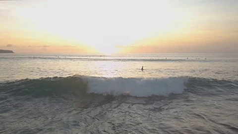Surfers are waiting for the waves in the sunset time aerial footage Stock Footage 100653493