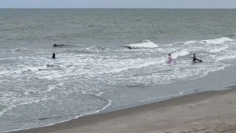 Surfers on the beach Stock Footage 231176800