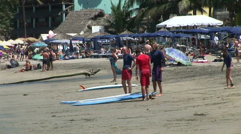 Surfers on a beach in Mexico Stock Footage 574042