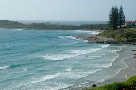 Surfers at a beach. Stock Photos