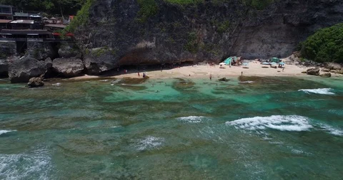 Surfers catch and ride the wave on reef. Turquoise ocean and the waves crashing Video stock 88229979
