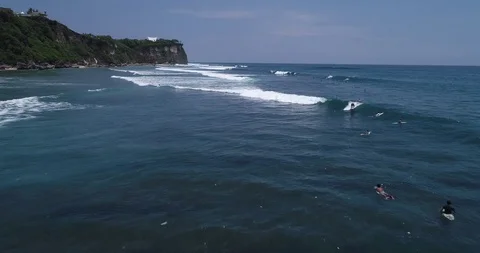 Surfers catch and ride the wave on reef. Turquoise ocean and the waves crashing Video stock 88230023
