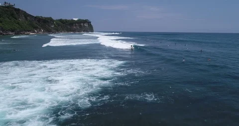 Surfers catch and ride the wave on reef. Turquoise ocean and the waves crashing Video stock 88230041