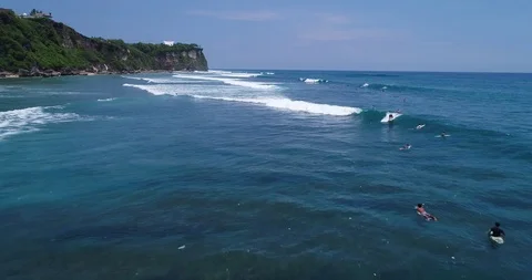 Surfers catch and ride the wave on reef. Turquoise ocean and the waves crashing Video stock 88230085