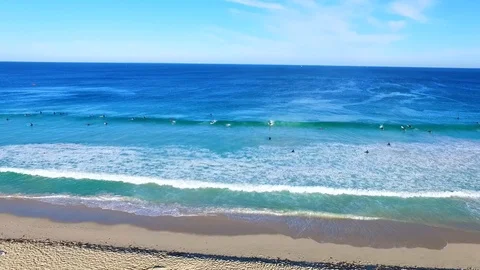 Surfers catching waves at the beach in summer Stock Footage 92576286
