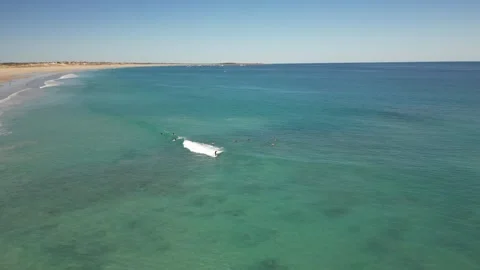 Surfers Catching Waves Breaking Over White Sand Cable Beach Broome WA Stock Footage 276430296