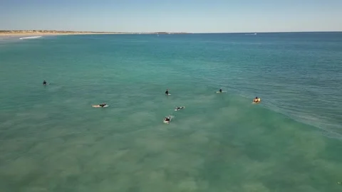Surfers Catching Waves Breaking Over White Sand Cable Beach Broome WA Stock Footage 276431049
