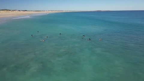 Surfers Catching Waves Breaking Over White Sand Cable Beach Broome WA Stock Footage 276431408