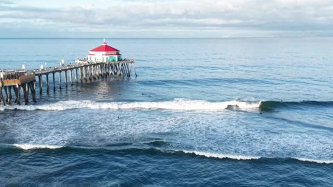 Surfers catching waves at Surf City USA. Huntington Beach California Stock Footage 338175458
