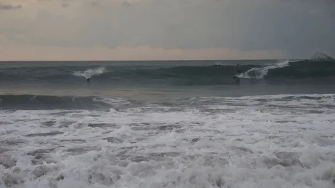 Surfers conquer the waves of the ocean Video stock 120532246