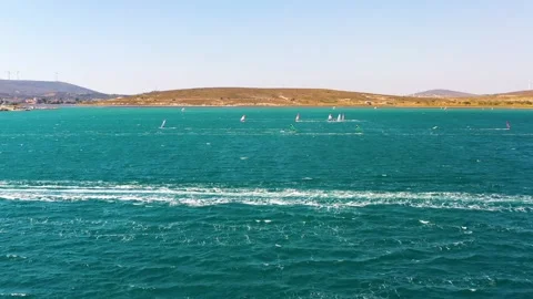 Surfers doing windsurfing at Turkey's world famous Cesme Alacati Beach Video stock 240853429