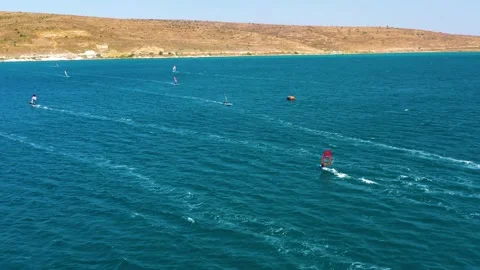 Surfers doing windsurfing at Turkey's world famous Cesme Alacati Beach 库存影片 240853498