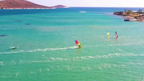 Surfers doing windsurfing at Turkey's world famous Cesme Alacati Beach Stock Footage 240853530