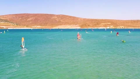 Surfers doing windsurfing at Turkey's world famous Cesme Alacati Beach Stock Footage 240853718