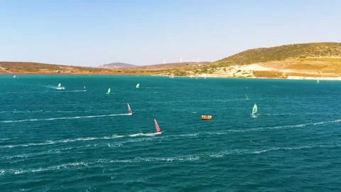 Surfers doing windsurfing at Turkey's world famous Cesme Alacati Beach Stockbeeldmateriaal 240853838