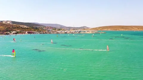 Surfers doing windsurfing at Turkey's world famous Cesme Alacati Beach Stockbeeldmateriaal 240853920