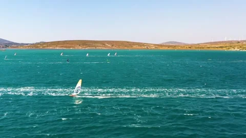 Surfers doing windsurfing at Turkey's world famous Cesme Alacati Beach Stock Footage 240853963