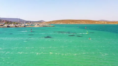 Surfers doing windsurfing at Turkey's world famous Cesme Alacati Beach Stock Footage 240854006