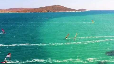Surfers doing windsurfing at Turkey's world famous Cesme Alacati Beach Video stock 240854039