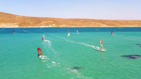 Surfers doing windsurfing at Turkey's world famous Cesme Alacati Beach Stock Footage 240854094