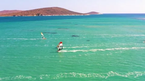Surfers doing windsurfing at Turkey's world famous Cesme Alacati Beach Stock Footage 240854112