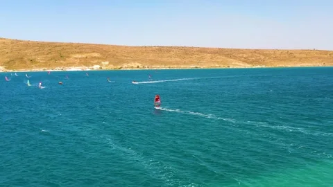 Surfers doing windsurfing at Turkey's world famous Cesme Alacati Beach Stock Footage 240854145