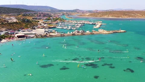 Surfers doing windsurfing at Turkey's world famous Cesme Alacati Beach Vídeo Stock 240854194