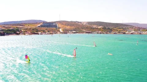Surfers doing windsurfing at Turkey's world famous Cesme Alacati Beach Stock Footage 240854212
