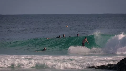 Surfers enjoying large waves during a morning surfing session at Snapper Rocks. Stock Footage 327532428