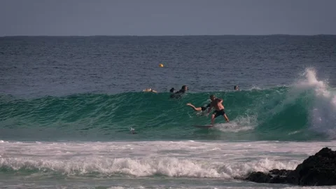 Surfers enjoying large waves during a morning surfing session at Snapper Rocks. Stock Footage 327532506