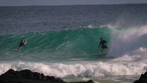 Surfers enjoying large waves during a morning surfing session at Snapper Rocks. Stock Footage 327532767