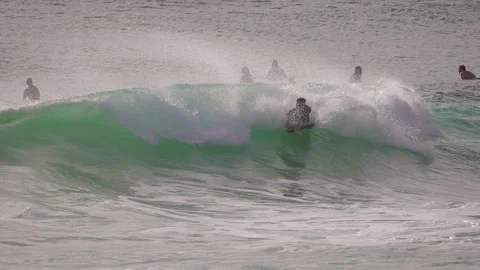 Surfers enjoying large waves during a morning surfing session at Duranbah Beach. Stockbeeldmateriaal 331385952
