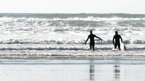 Surfers Enter The Breakers In Rough Ocean Water Stock Footage 121288719