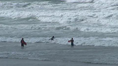 Surfers Entering Ocean Stock Footage 18172931