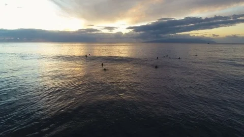 Surfers Floating In The Ocean During Sunset Stock Footage 76745098