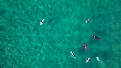Surfers Floating With Surfboards On Pristine Water 動画素材 227304850
