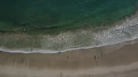 Surfers' Haven: Top-Down Drone View of the Action at Selong Belanak Beach Stock Footage 259559625
