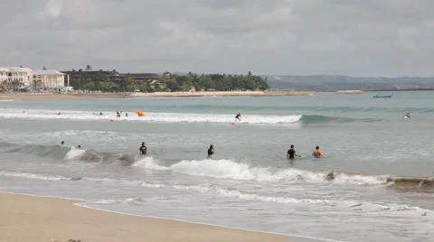 Surfers on the Kuta beach  Stockbeeldmateriaal 1102290