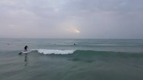 Surfers learn to catch a wave in the sea, Spain, Alicante Stock Footage 322173767