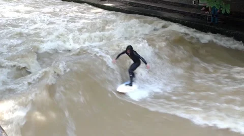 Surfers on a man-made wave  on the Eisbach river Stock Footage 66610108