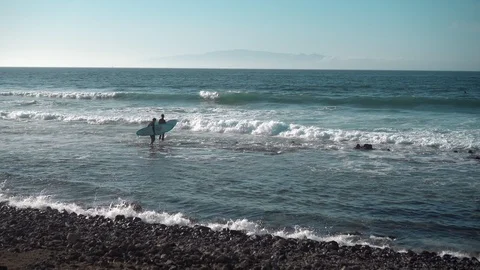 Surfers on Ocean Coast Stock Footage 121857162