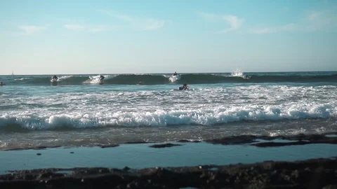 Surfers on Ocean Coast Stock Footage 121857247