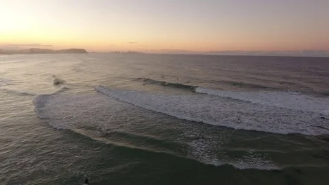 Surfers in ocean at sunset Stock Footage 76215654