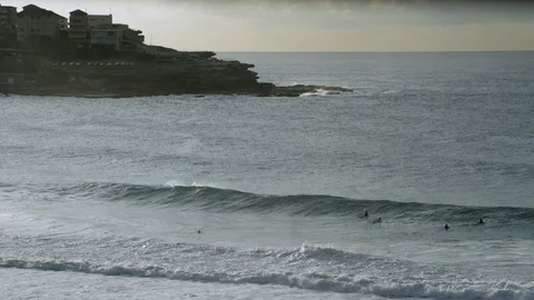 Surfers Paddle Through Waves Stock Footage 94102358