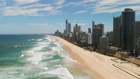 Premium stock video - Looking back at surfers paradise from water with drone