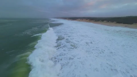 Surfer's perspective gliding through ocean waves at dawn Stock Footage 345148718