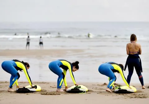 Surfers practice in the Zurriola beach, San Sebastian, Spain - 03 Jun 2019 Stock Photos