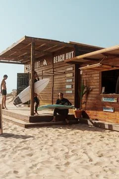 Surfers preparing in front of a beach hut rental in Algarve, Portugal Stock Photos